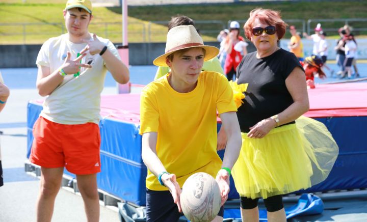 Students and adult play with a rugby ball at Sports Carnival 2018